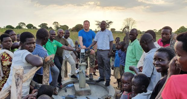 Alex Gason of the Fields of Life NGO and Peter Mawanga from the Kumi District Water office inspecting a Smart Water installation in Oogoria, Uganda